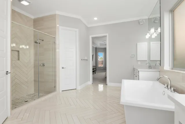 a bathroom with a bathtub shower sink and mirror