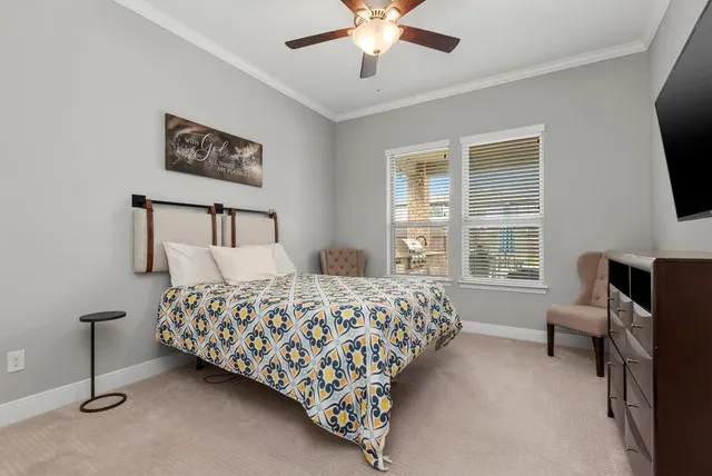 a bedroom with bed and a flat screen tv