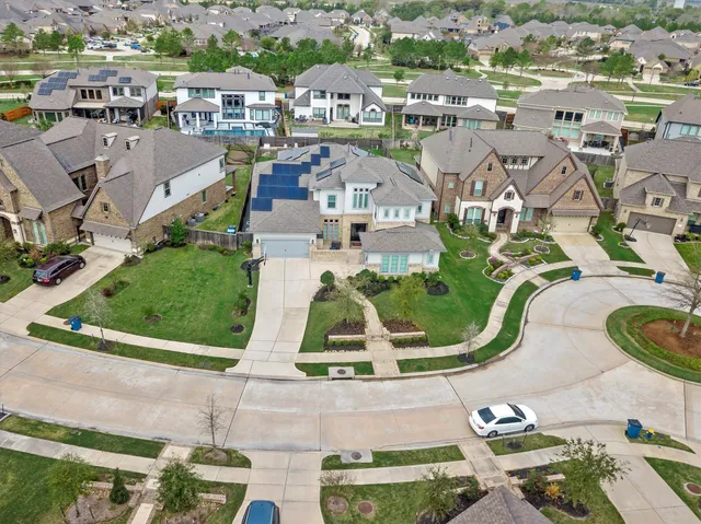 an aerial view of residential houses with outdoor space