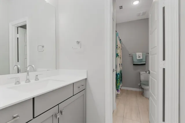 a en suite bathroom with a sink and a mirror