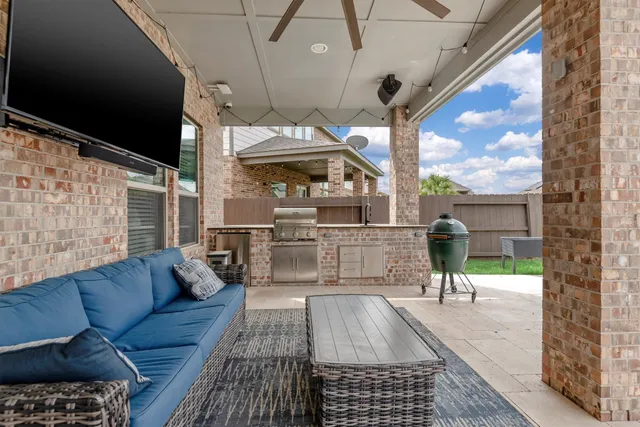 a view of a living room and a balcony with furniture