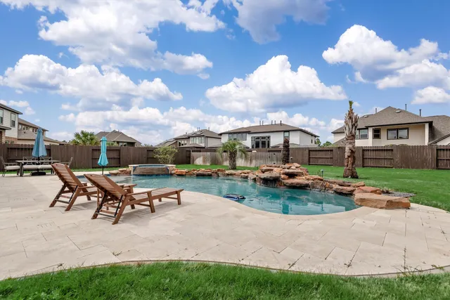 a view of a backyard with sitting area