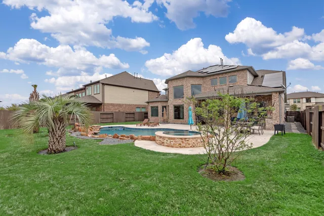 a view of a house with a backyard porch and sitting area