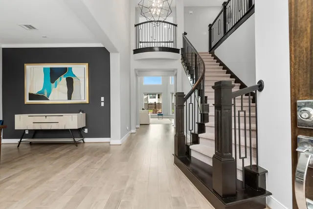 a view of entryway and hall with wooden floor