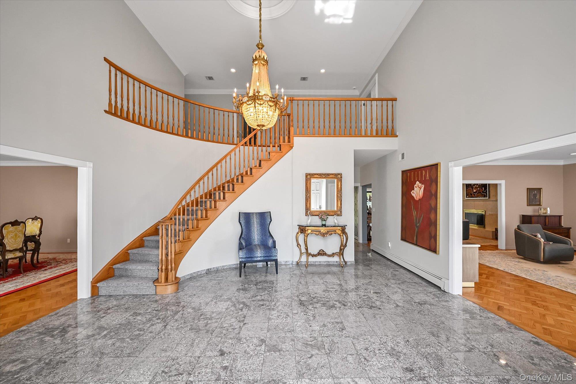 85 Meadow Woods Road Great Neck, NY 11020 - Photo 2 of 25 This stunning foyer boasts a cathedral ceiling with custom finishes, granite floors, and a sweeping staircase leading to the second floor.
