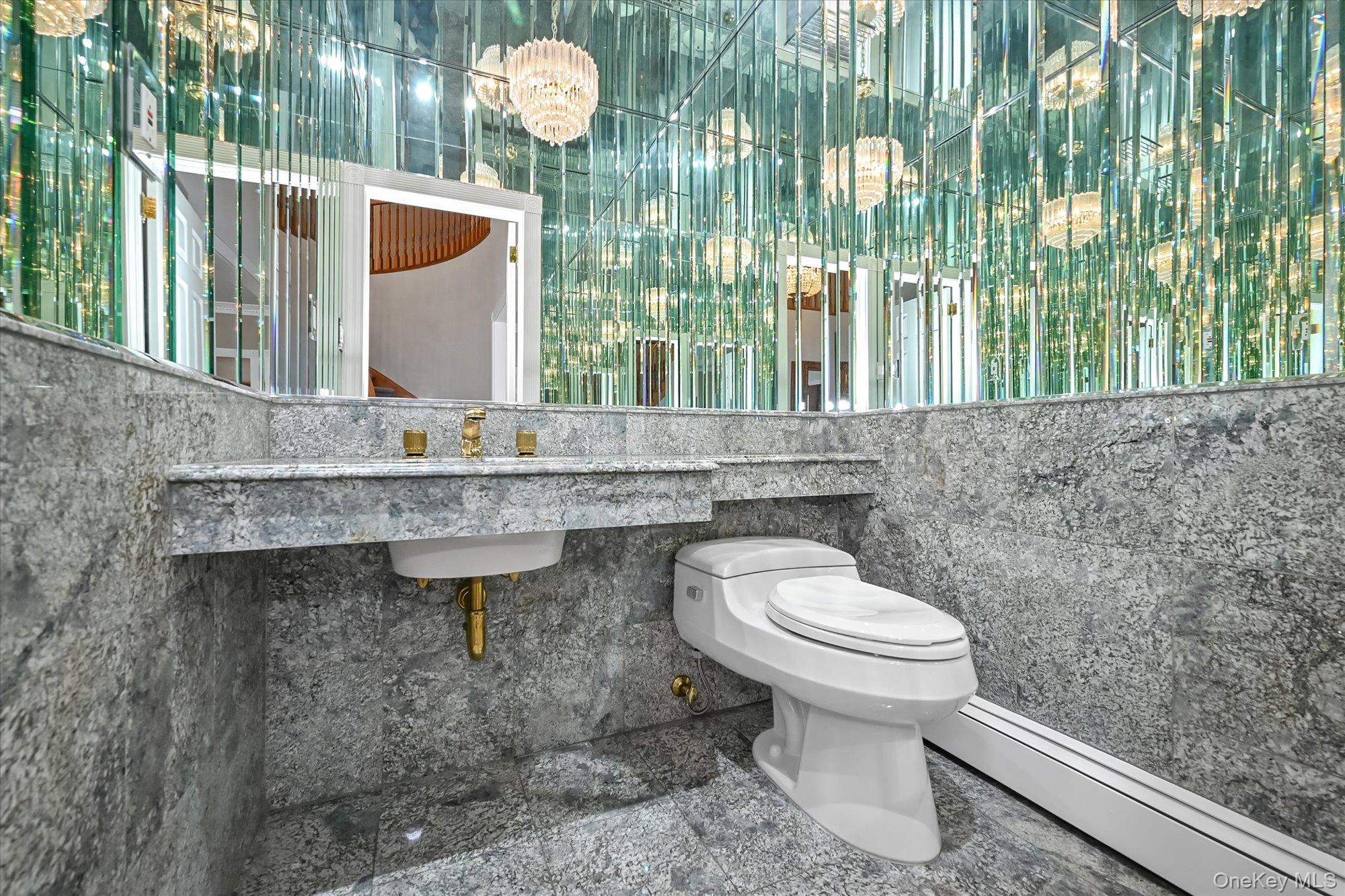 85 Meadow Woods Road Great Neck, NY 11020 - Photo 9 of 25 A powder room is conveniently situated in the entrance foyer.