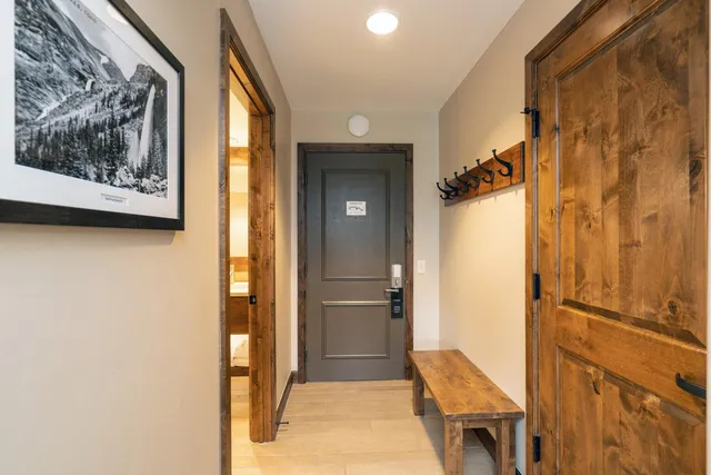 a view of a hallway with wooden floor and dining room