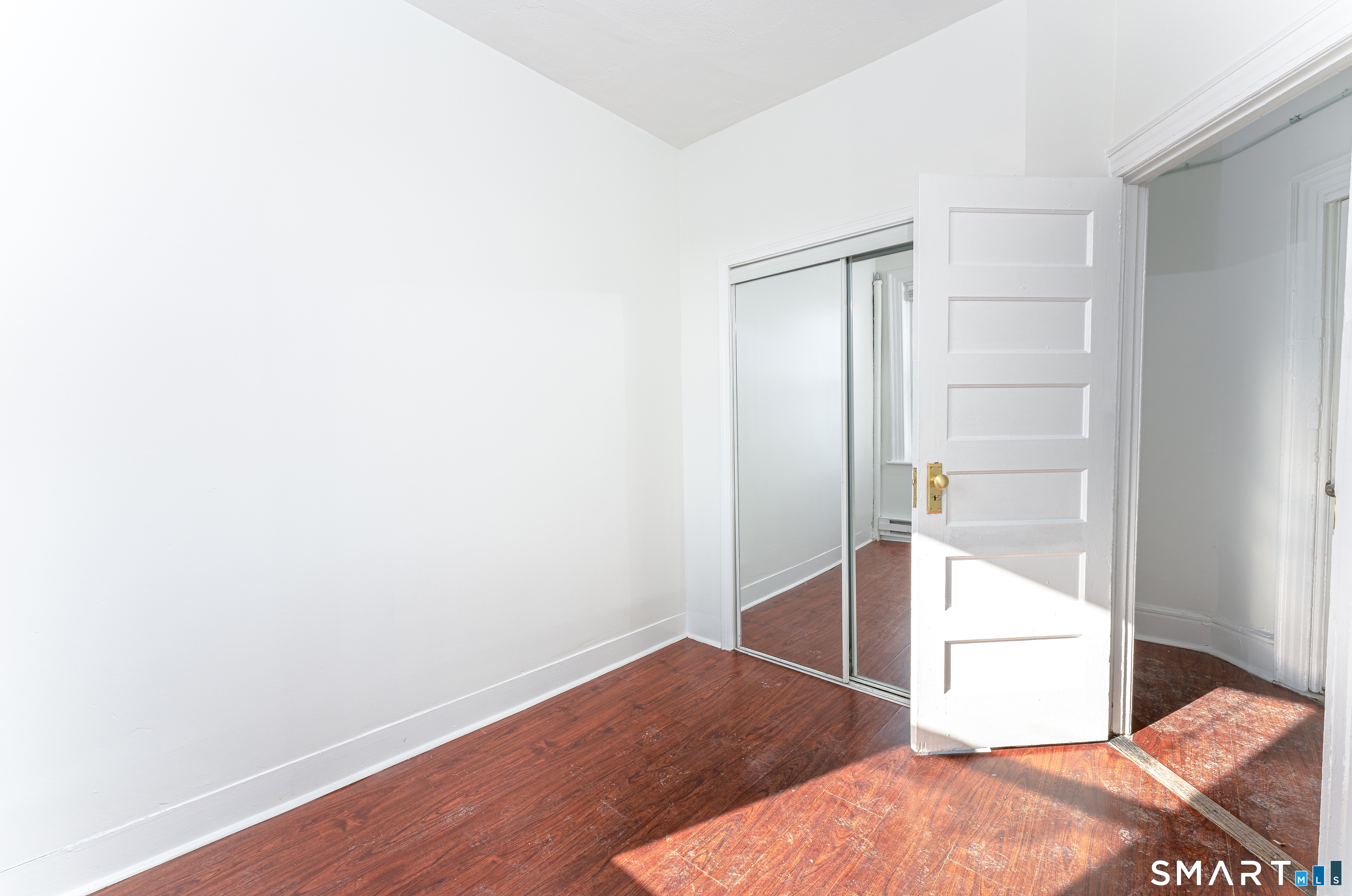 35 Butler Avenue, Unit 5 Bridgeport, CT 06605 - Photo 19 of 25 a view of wooden floor and closet in an empty room