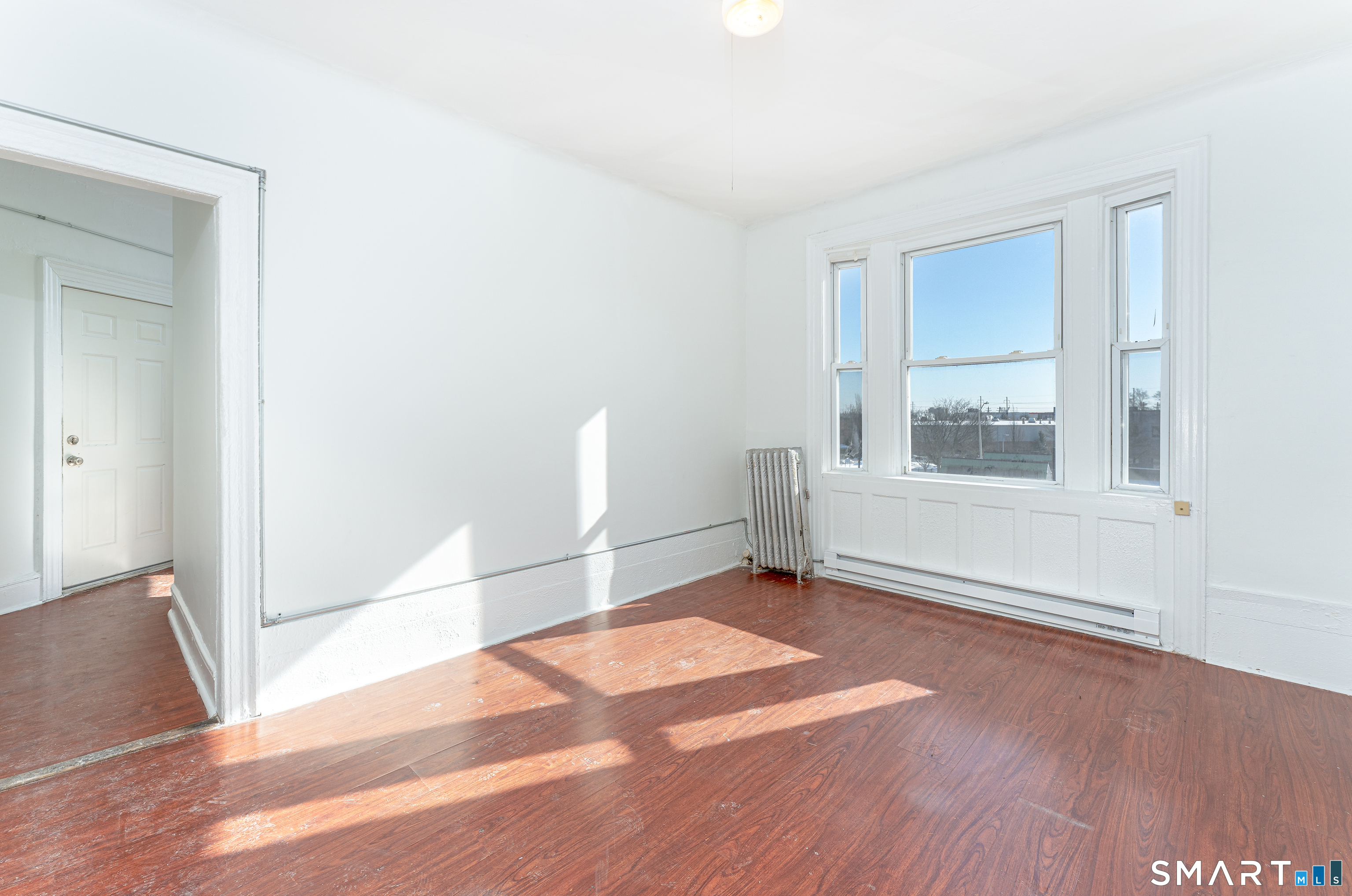 35 Butler Avenue, Unit 5 Bridgeport, CT 06605 - Photo 23 of 25 a view of empty room with wooden floor and fan