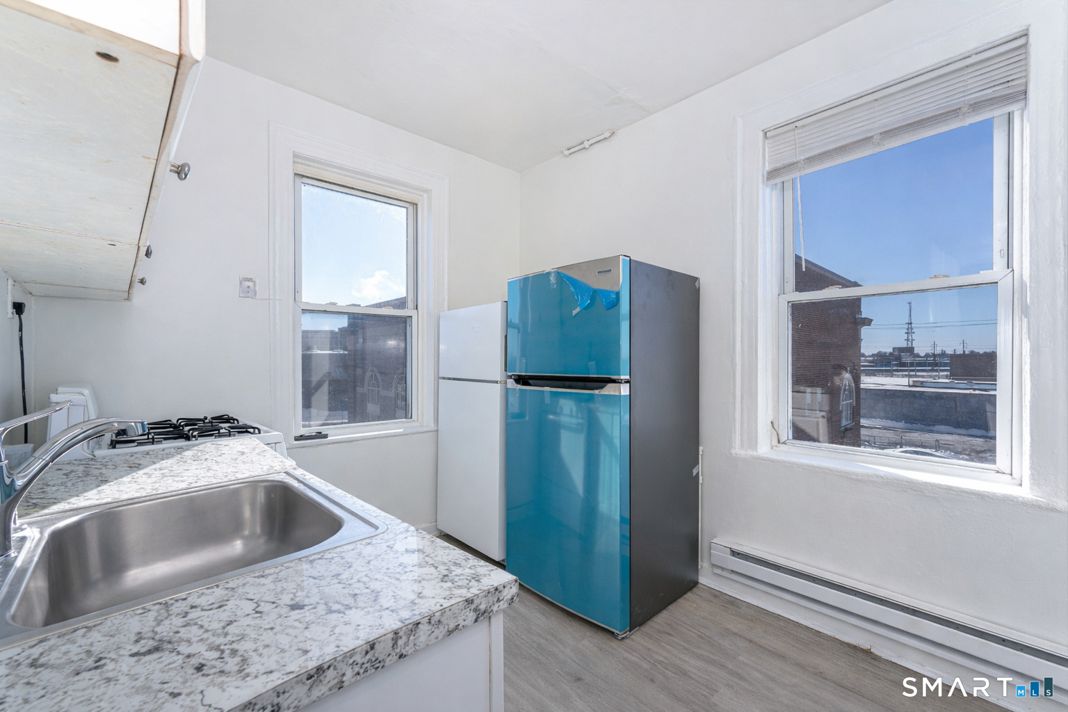 35 Butler Avenue, Unit 5 Bridgeport, CT 06605 - Photo 8 of 25 a kitchen with a refrigerator sink and cabinets