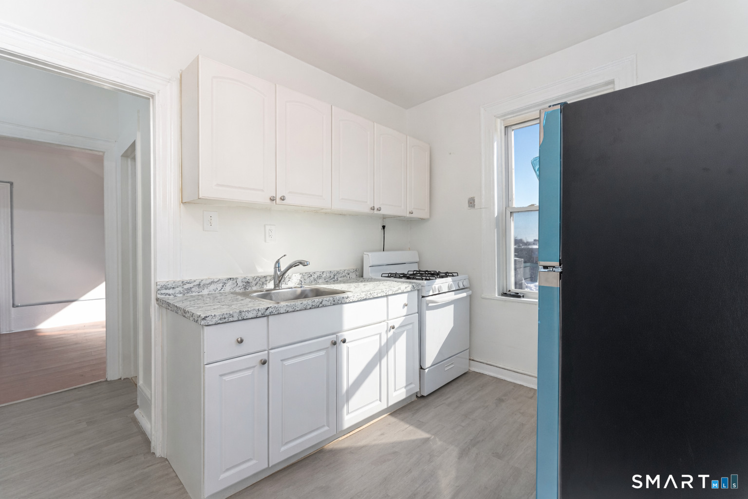 35 Butler Avenue, Unit 5 Bridgeport, CT 06605 - Photo 9 of 25 a kitchen with granite countertop a sink and cabinets