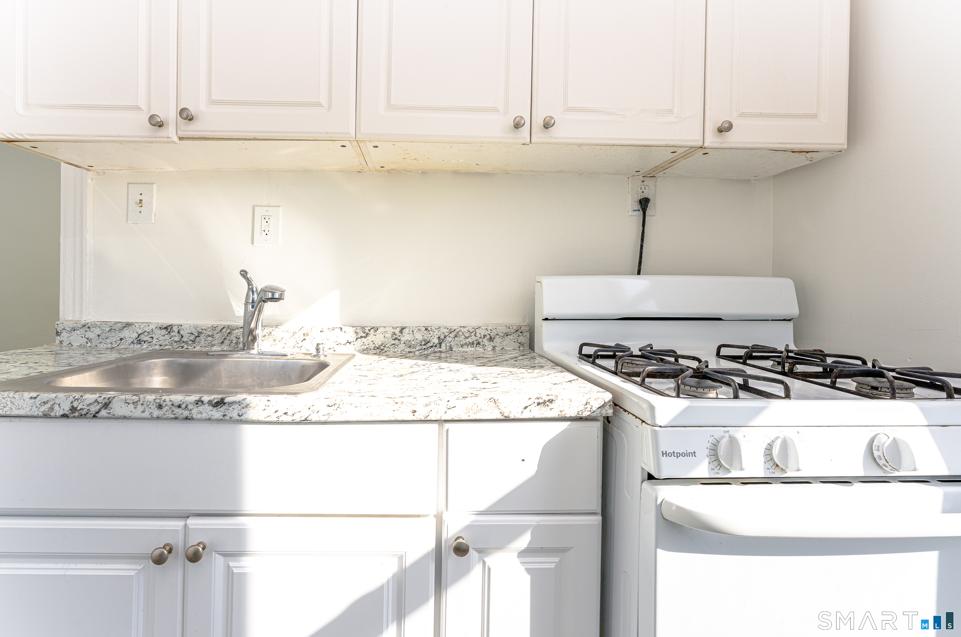 35 Butler Avenue, Unit 5 Bridgeport, CT 06605 - Photo 10 of 25 a kitchen with granite countertop a stove and a sink