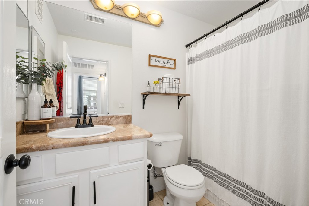 52 Valmont Way Ladera Ranch, CA 92694 - Photo 23 of 59 a bathroom with a granite countertop sink mirror vanity and toilet
