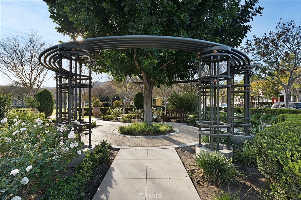 52 Valmont Way Ladera Ranch, CA 92694 - Photo 50 of 59 a view of a patio with table and chairs under an umbrella with a small garden