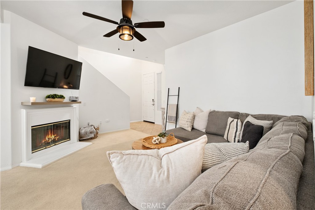 52 Valmont Way Ladera Ranch, CA 92694 - Photo 8 of 59 a living room with furniture and a fireplace