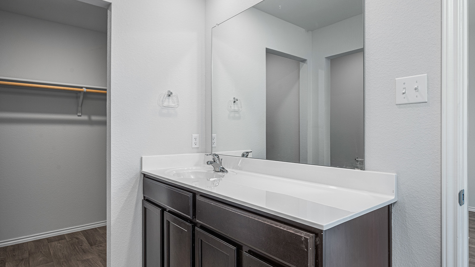 1303 Coriander Road Temple, TX 76501 - Photo 12 of 20 Dark wood-finish vanity with an integrated sink and white countertop