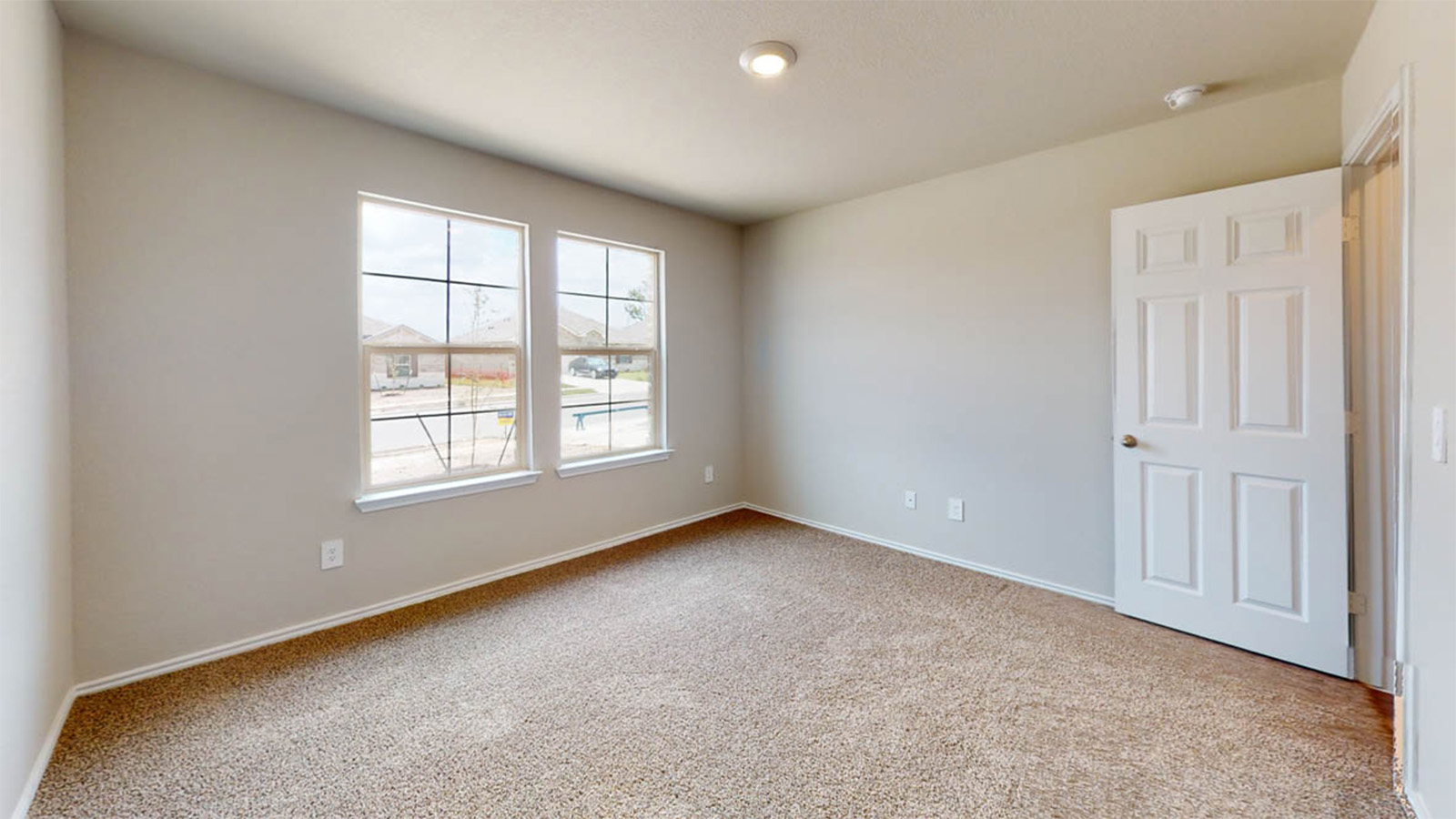 1303 Coriander Road Temple, TX 76501 - Photo 15 of 20 Carpeted room featuring two large windows, neutral wall paint, white baseboards, and a recessed ceiling light fixture