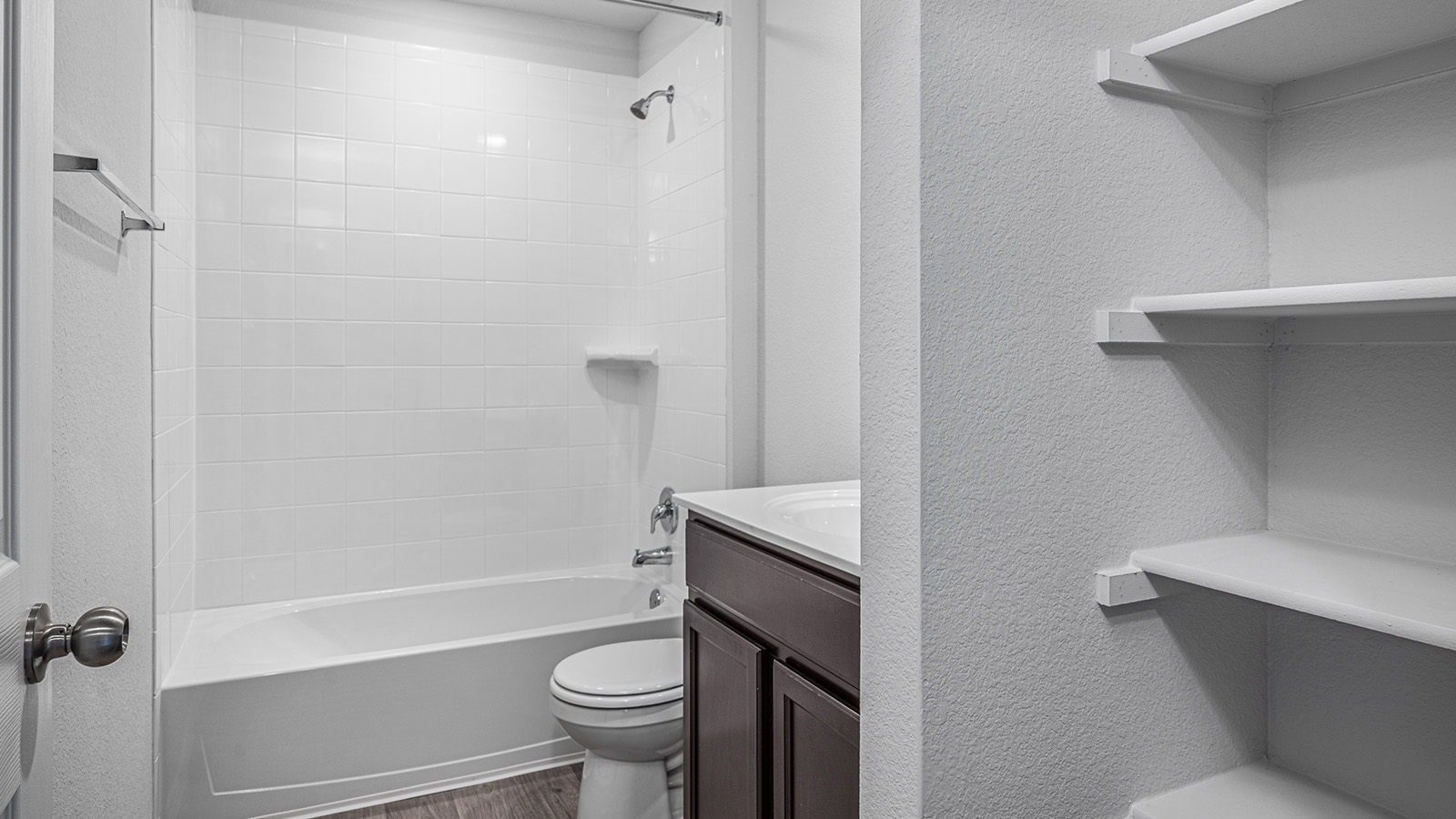 1303 Coriander Road Temple, TX 76501 - Photo 18 of 20 Bathroom featuring a white subway tile surround, integrated showerhead, and a white porcelain tub