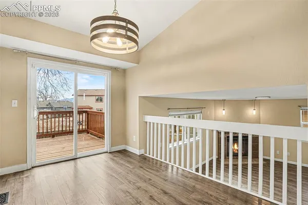 a view of a livingroom with wooden floor and iron gate