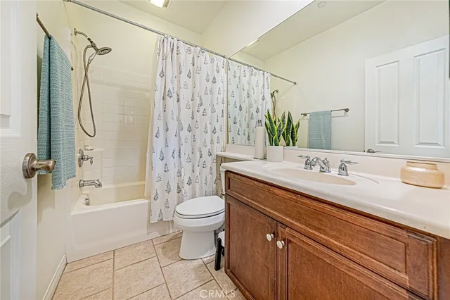 a bathroom with a granite countertop sink toilet a shower and a mirror