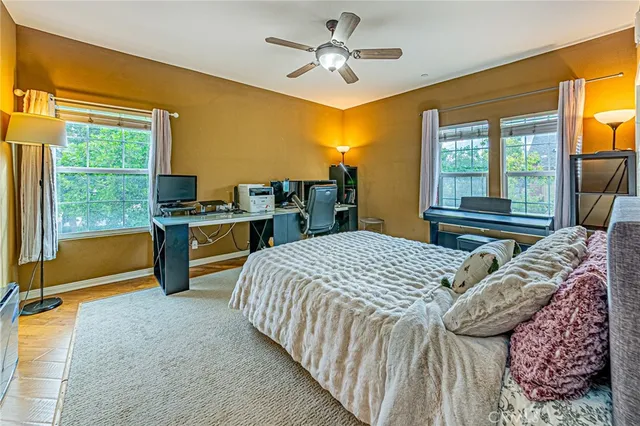 a bed sitting in a bedroom next to a window
