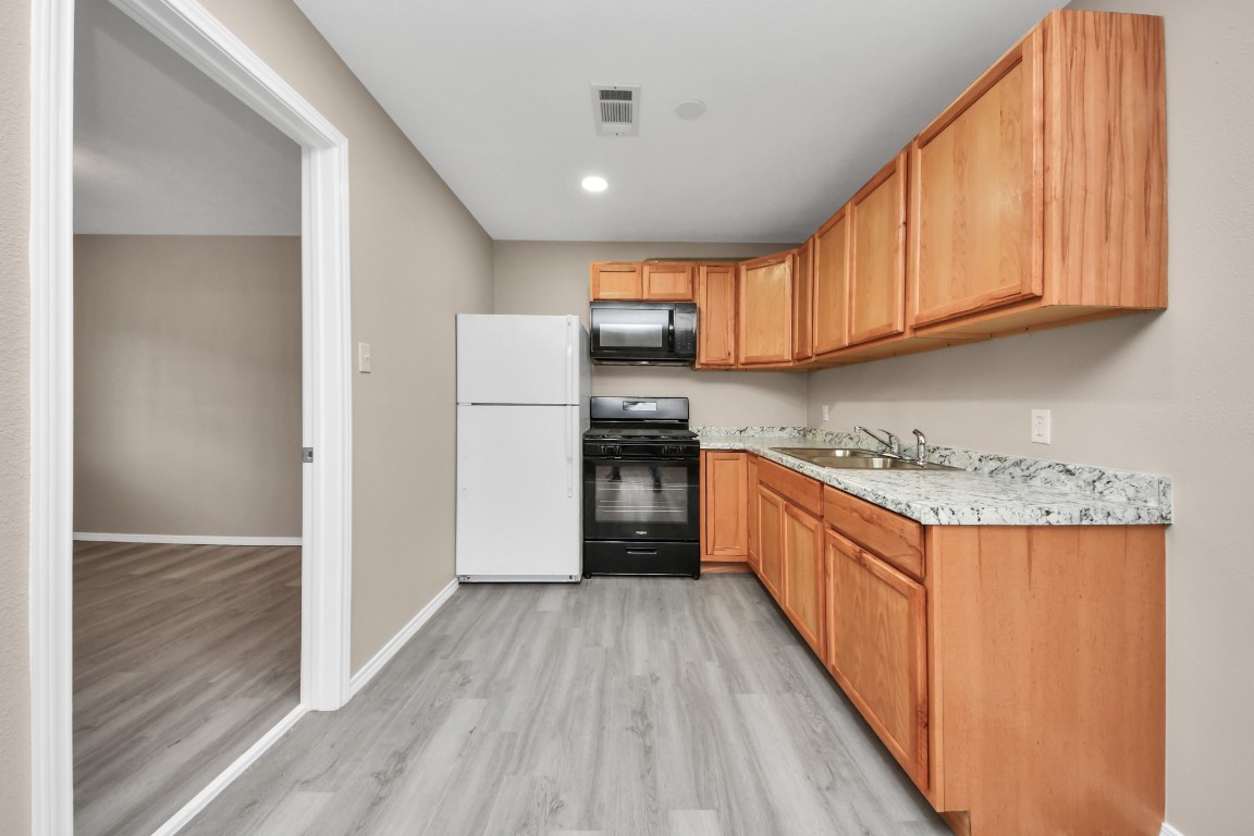 17111 River Road, Unit A Channelview, TX 77530 - Photo 6 of 19 All new kitchen cabinets and refrigerator.