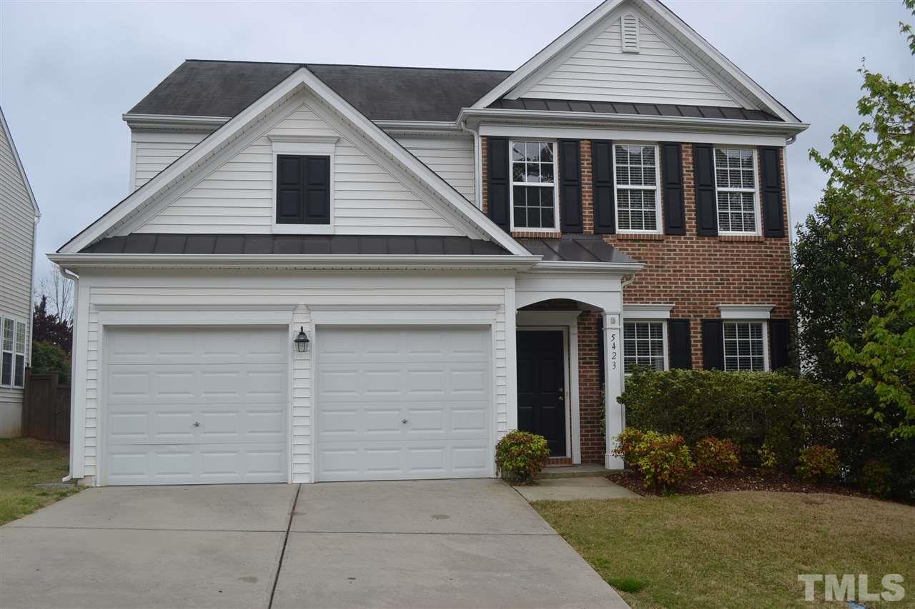 5423 Shaker Heights Lane Raleigh, NC 27613 - Photo 1 of 24 a front view of a house with a yard and garage