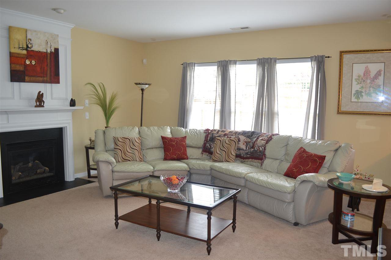 5423 Shaker Heights Lane Raleigh, NC 27613 - Photo 12 of 24 a living room with furniture and a fireplace