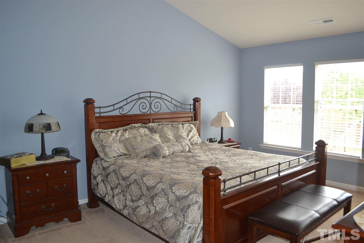 5423 Shaker Heights Lane Raleigh, NC 27613 - Photo 15 of 24 a bed sitting in a bedroom next to a window