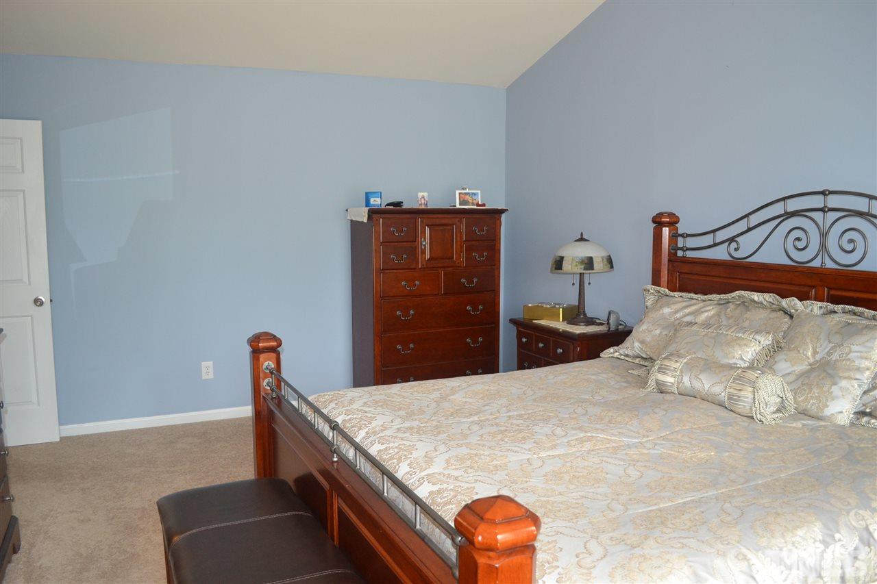 5423 Shaker Heights Lane Raleigh, NC 27613 - Photo 16 of 24 a bedroom with a bed and a dresser