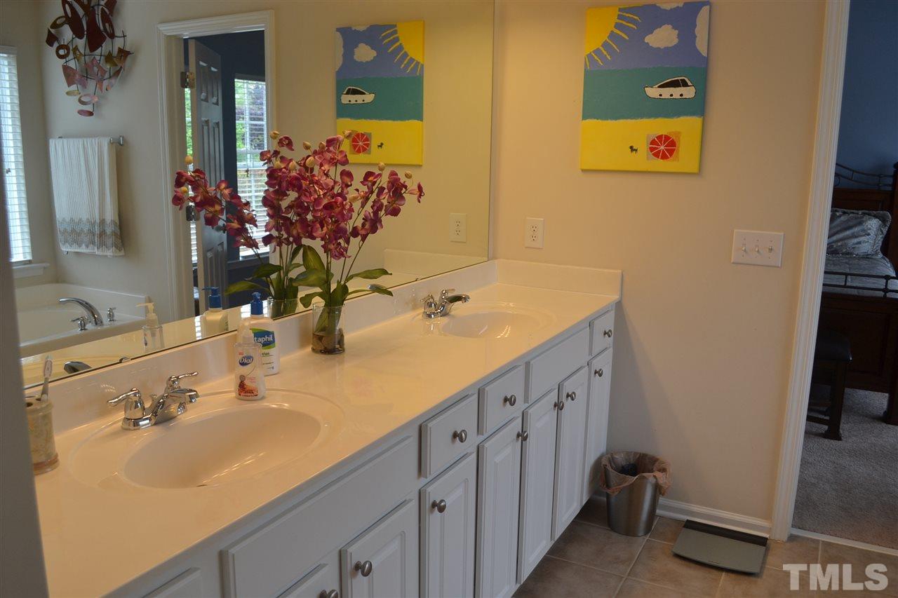 5423 Shaker Heights Lane Raleigh, NC 27613 - Photo 17 of 24 a bathroom with a sink and a mirror