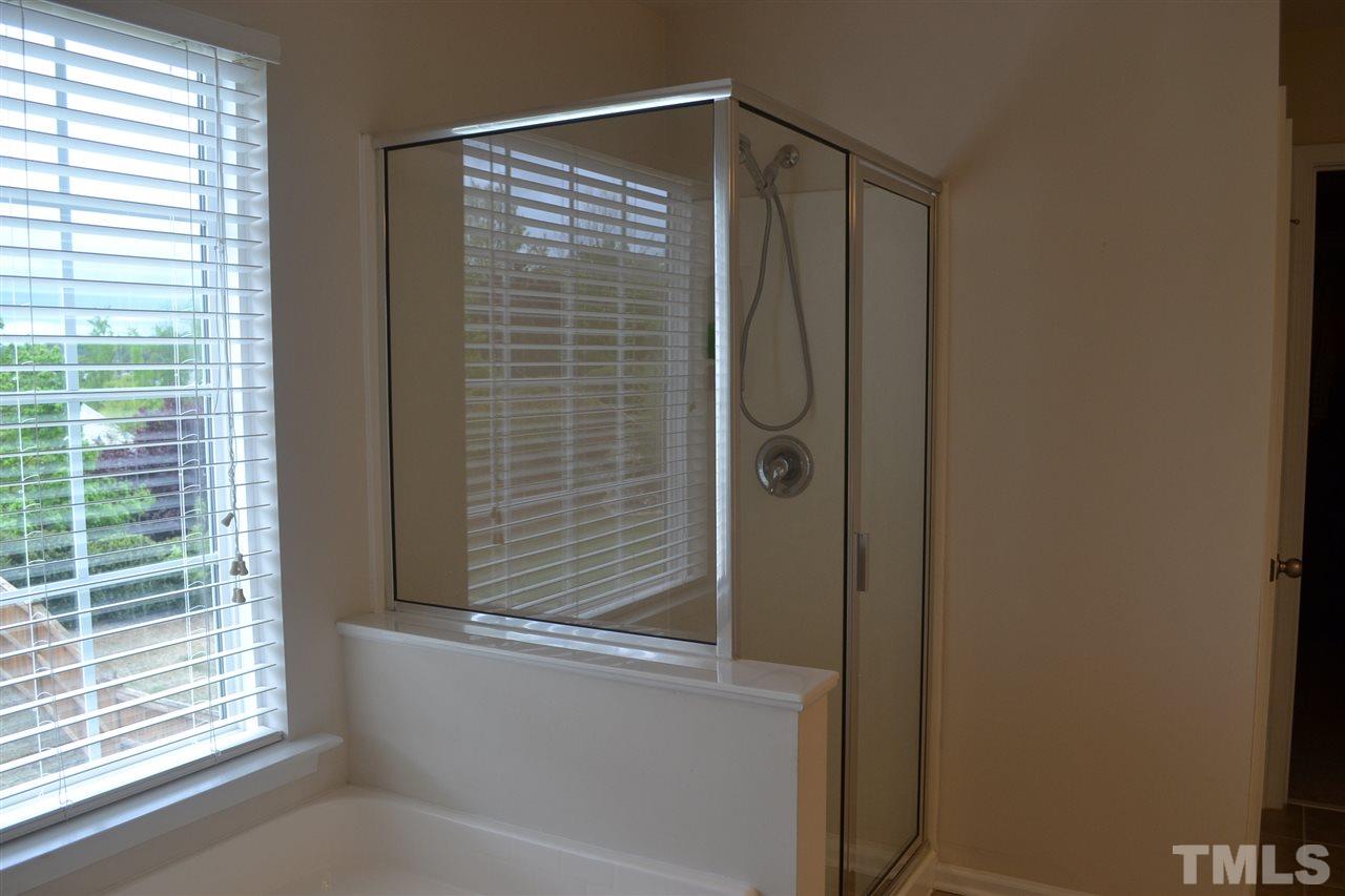 5423 Shaker Heights Lane Raleigh, NC 27613 - Photo 19 of 24 a bathroom with a shower and a window