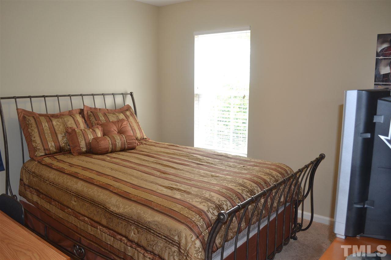 5423 Shaker Heights Lane Raleigh, NC 27613 - Photo 20 of 24 a bedroom with a bed and a window