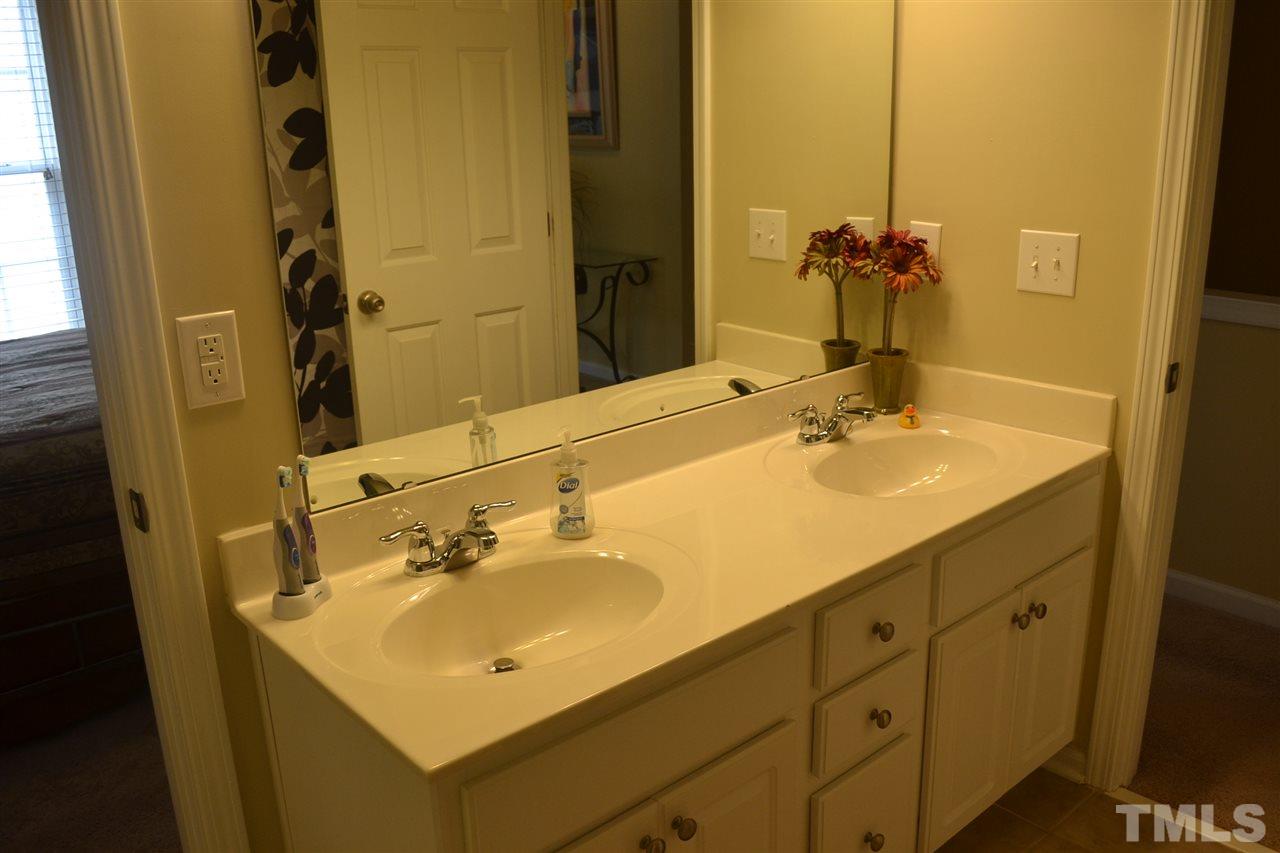 5423 Shaker Heights Lane Raleigh, NC 27613 - Photo 21 of 24 a bathroom with a sink and a mirror