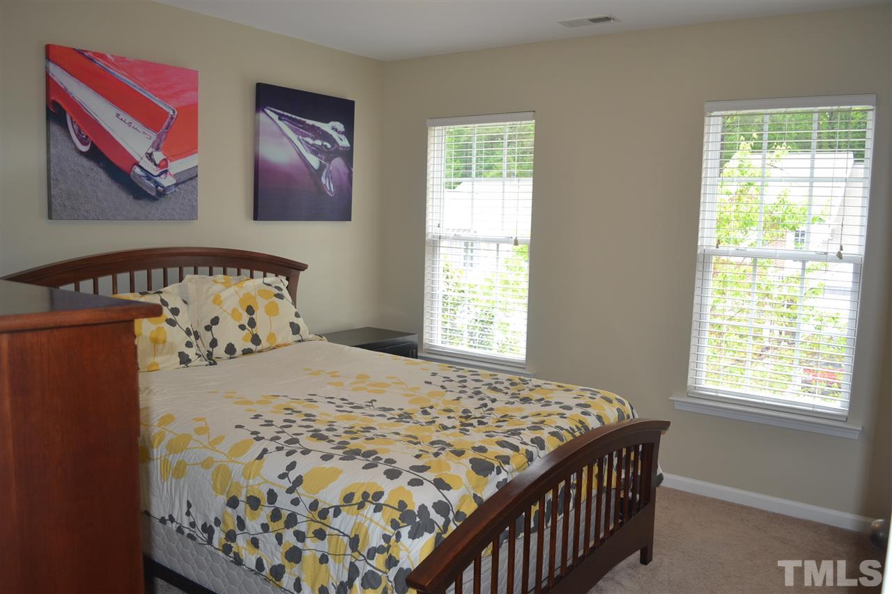 5423 Shaker Heights Lane Raleigh, NC 27613 - Photo 22 of 24 a bedroom with a bed and a window