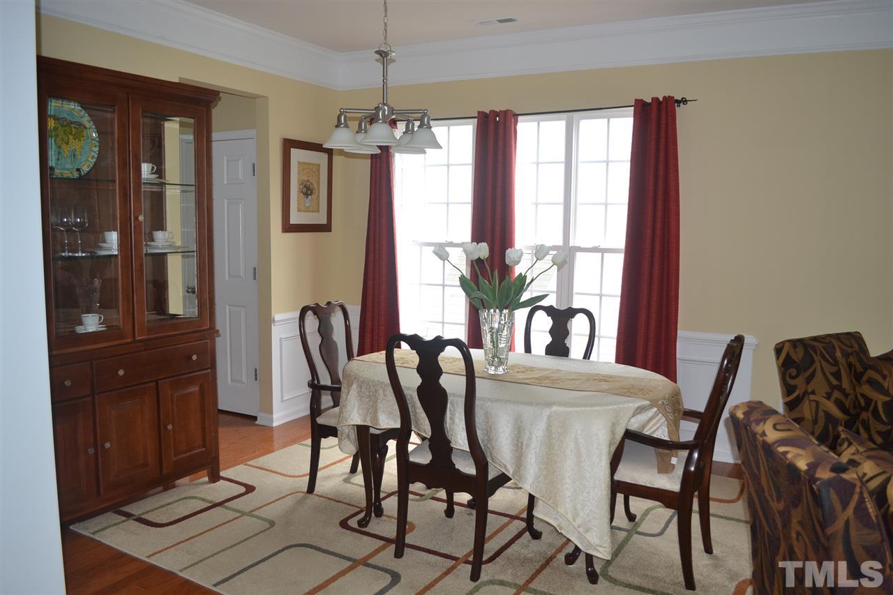 5423 Shaker Heights Lane Raleigh, NC 27613 - Photo 5 of 24 a view of a dining room with furniture and chandelier