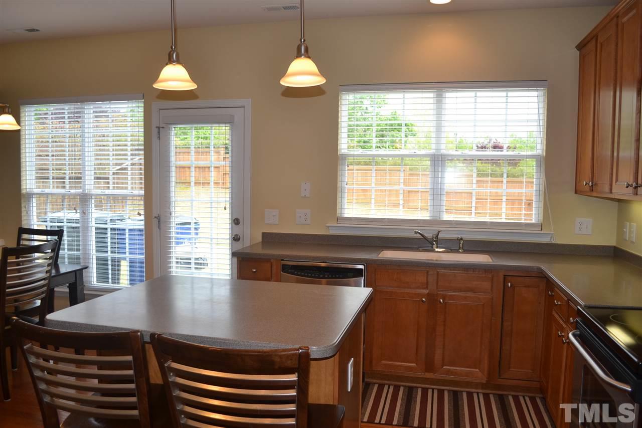 5423 Shaker Heights Lane Raleigh, NC 27613 - Photo 9 of 24 a kitchen with a sink a window and cabinets
