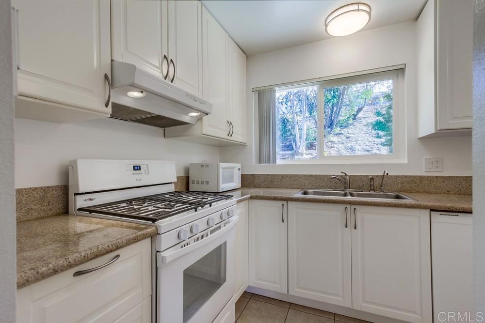 1376 Panorama Ridge Road Oceanside, CA 92056 - Photo 11 of 50 a kitchen with granite countertop stainless steel appliances a stove a sink and a window