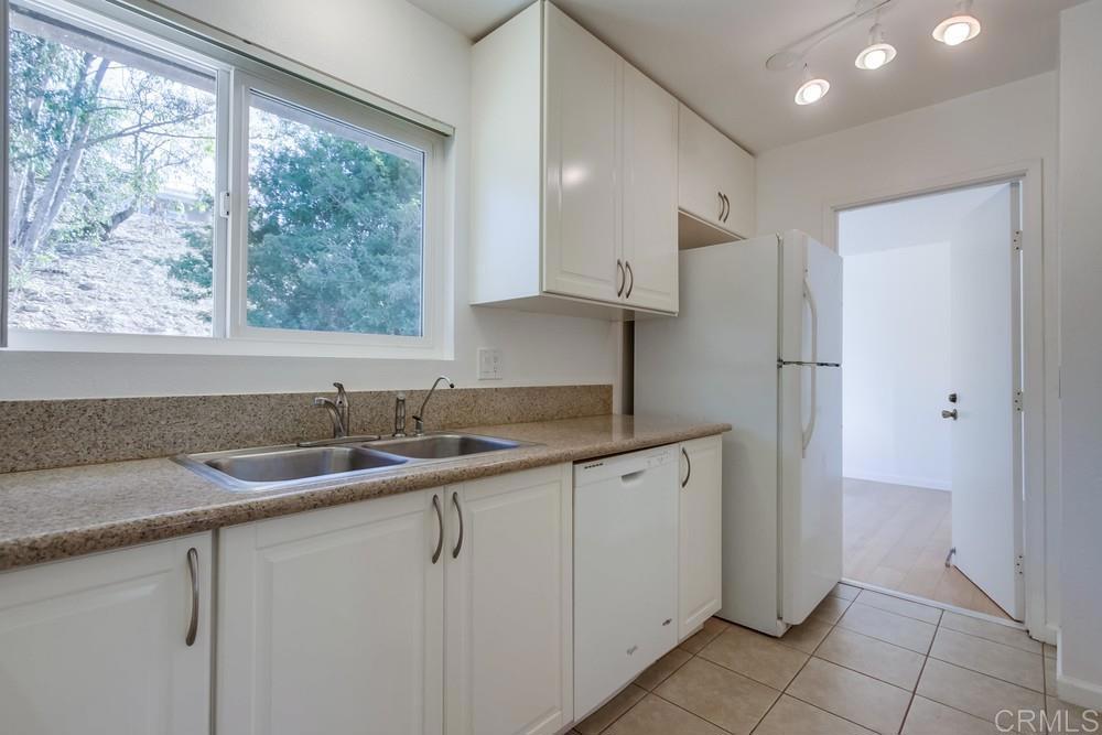 1376 Panorama Ridge Road Oceanside, CA 92056 - Photo 12 of 50 a kitchen with stainless steel appliances granite countertop a sink and a refrigerator