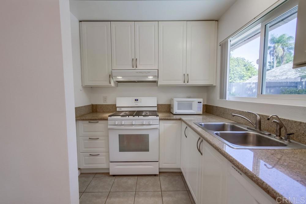 1376 Panorama Ridge Road Oceanside, CA 92056 - Photo 14 of 50 a kitchen with stainless steel appliances granite countertop a sink stove and refrigerator