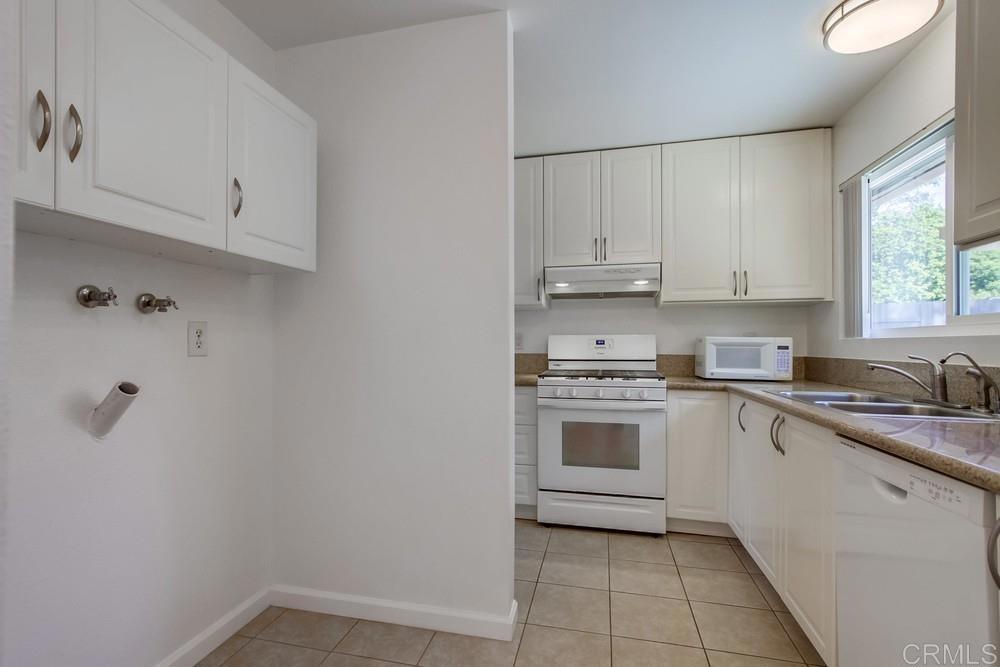 1376 Panorama Ridge Road Oceanside, CA 92056 - Photo 16 of 50 a kitchen with cabinets appliances a sink and a window