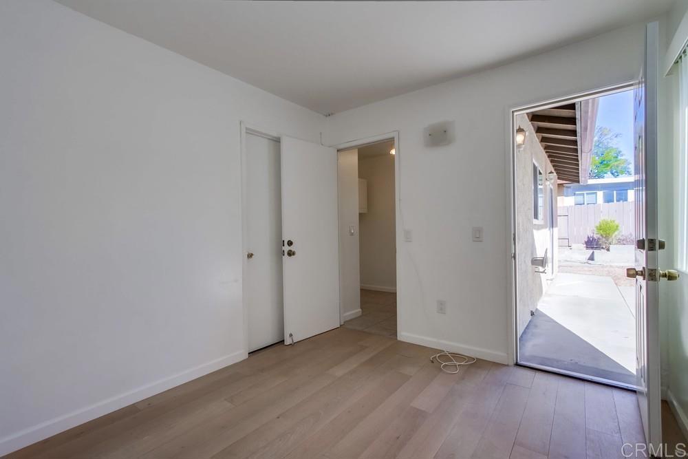1376 Panorama Ridge Road Oceanside, CA 92056 - Photo 18 of 50 an empty room with wooden floor and windows