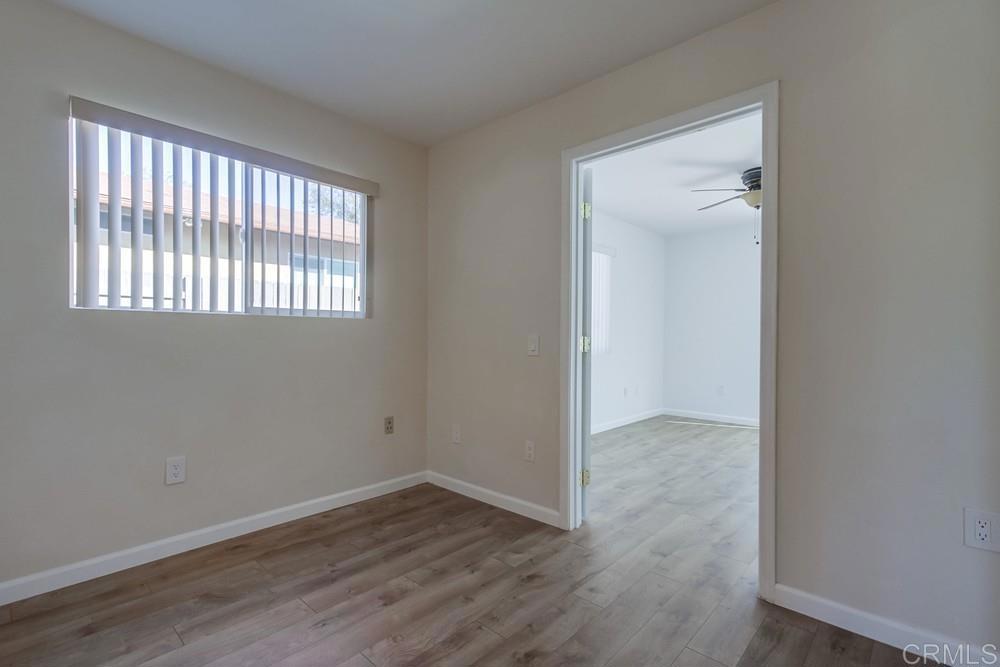 1376 Panorama Ridge Road Oceanside, CA 92056 - Photo 24 of 50 an empty room with wooden floor and windows