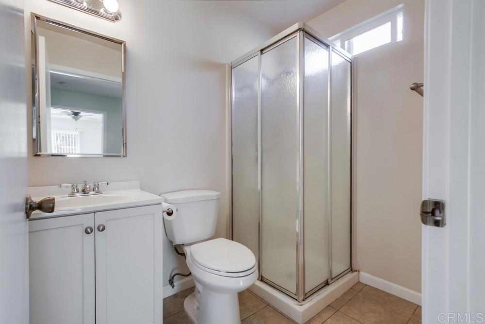 1376 Panorama Ridge Road Oceanside, CA 92056 - Photo 27 of 50 a bathroom with a toilet a sink and mirror