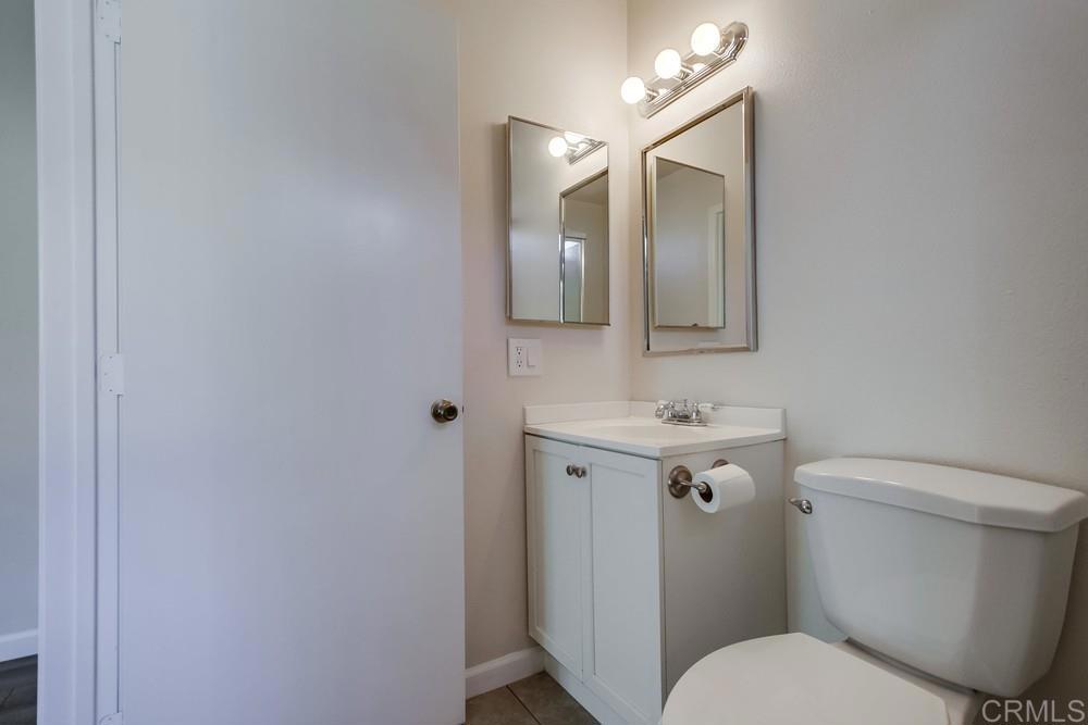 1376 Panorama Ridge Road Oceanside, CA 92056 - Photo 28 of 50 a bathroom with a toilet a sink and mirror