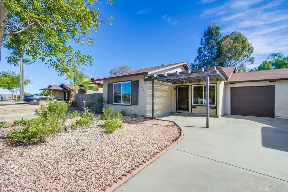 1376 Panorama Ridge Road Oceanside, CA 92056 - Photo 3 of 50 a front view of a house with a garden and outdoor seating