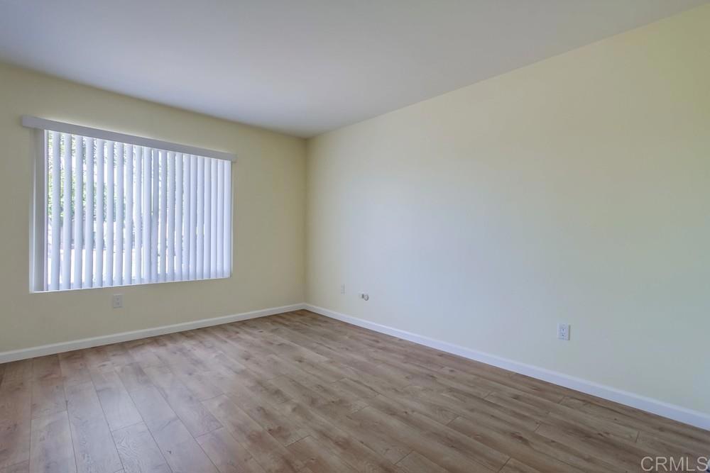1376 Panorama Ridge Road Oceanside, CA 92056 - Photo 31 of 50 an empty room with wooden floor and windows