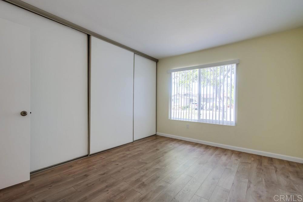 1376 Panorama Ridge Road Oceanside, CA 92056 - Photo 32 of 50 a view of an empty room with wooden floor and a window