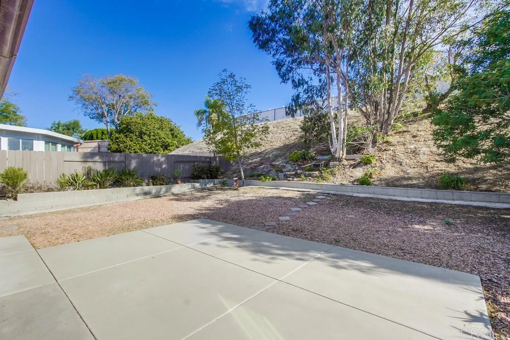 1376 Panorama Ridge Road Oceanside, CA 92056 - Photo 39 of 50 a view of a yard with plants and a bench