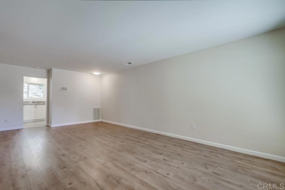 1376 Panorama Ridge Road Oceanside, CA 92056 - Photo 6 of 50 a view of an empty room with wooden floor and a window